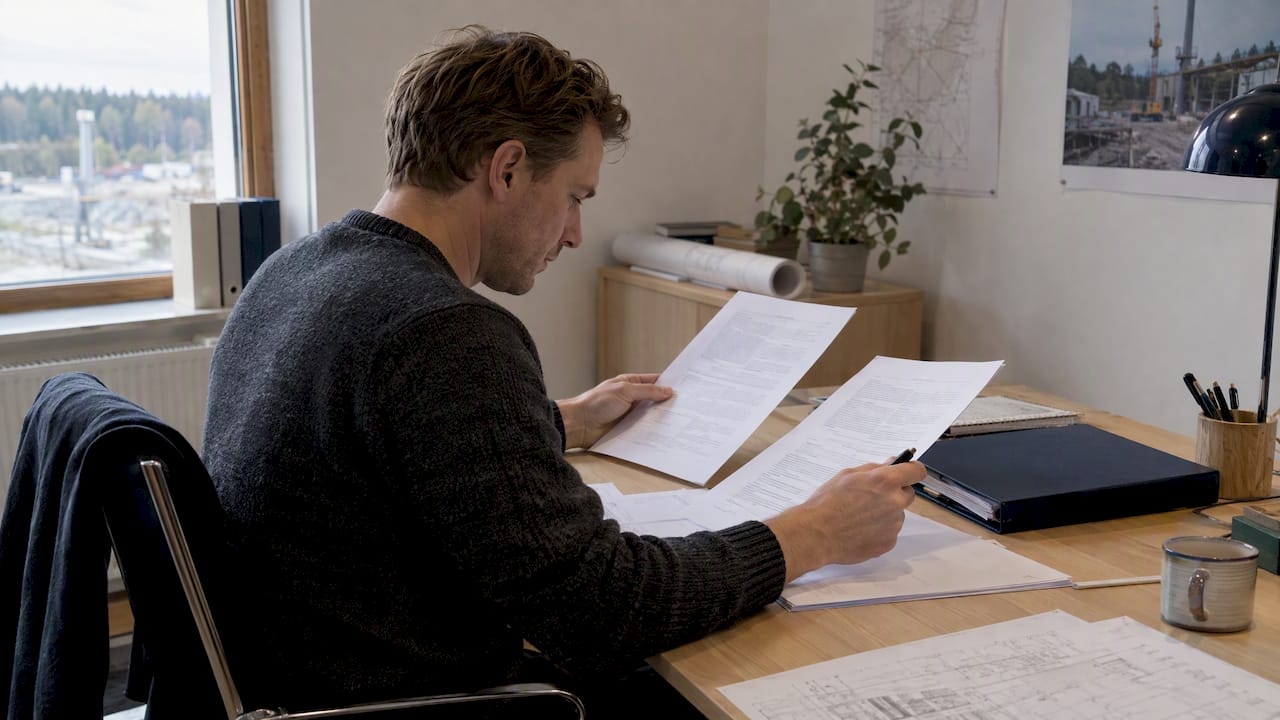Reviewer comparing construction tender contract versions