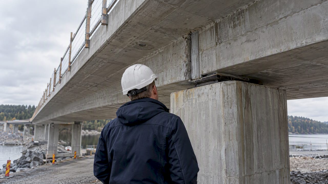 Engineer inspecting a concrete bridge joint