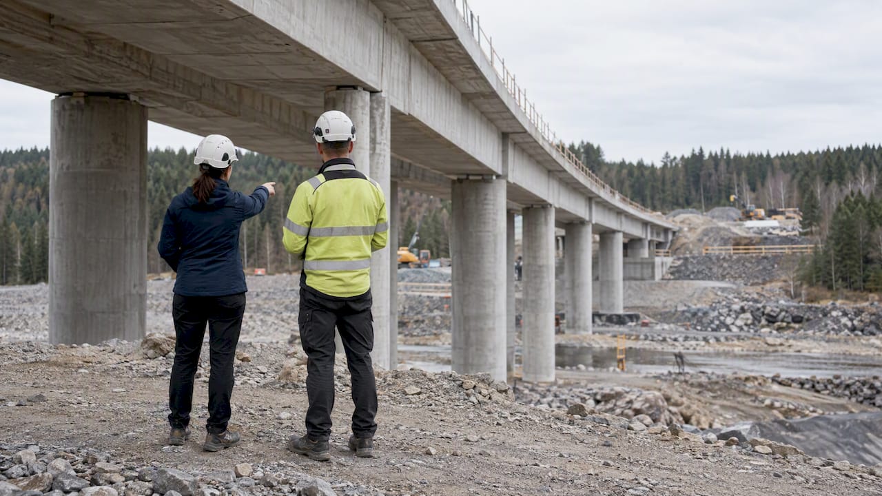 Engineers assessing concrete bridge supports